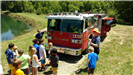 Firefighters talking to kids by a firetruck