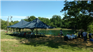Large tent and table for food set up by the lake