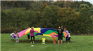 Kids and Adults Playing with Parachute