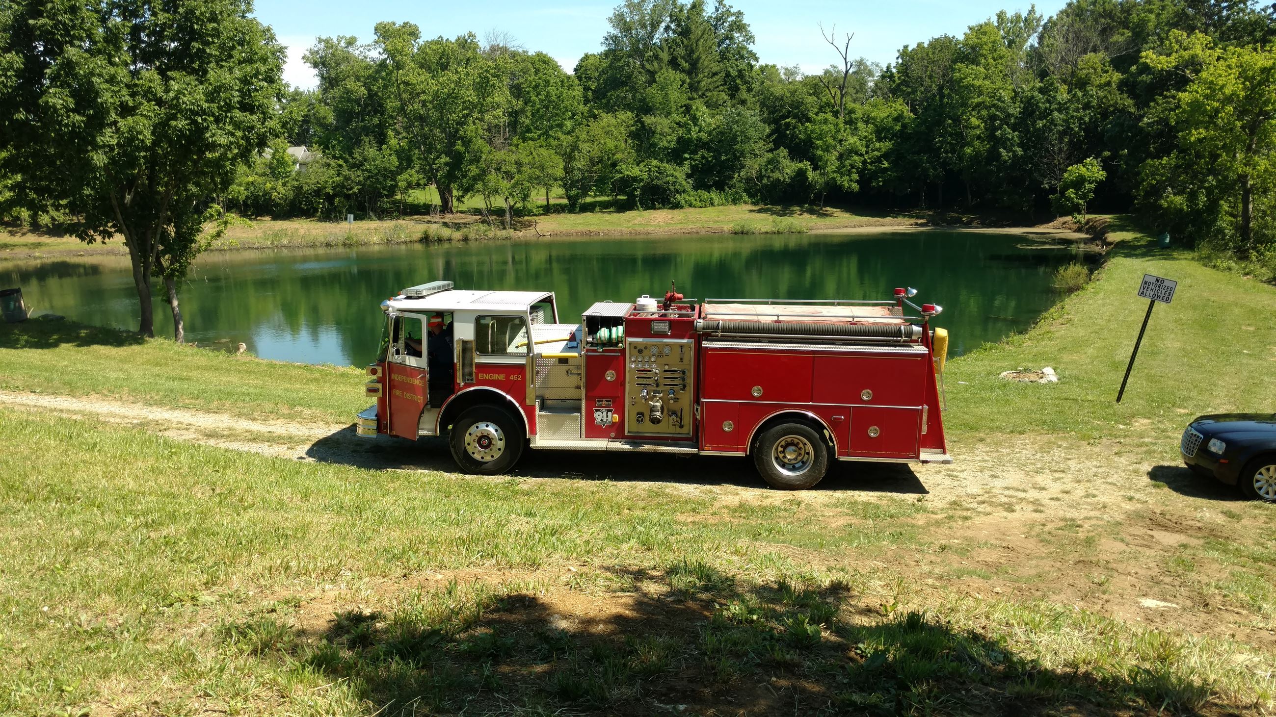 Fire truck parked by a lake