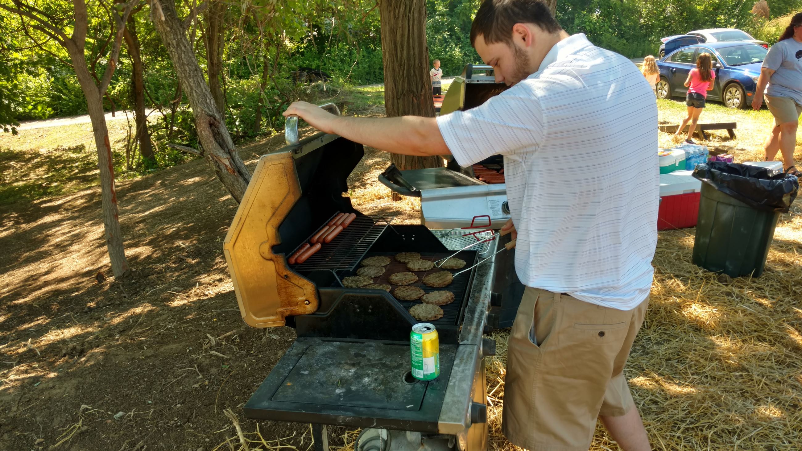 Man flipping burgers on a grill