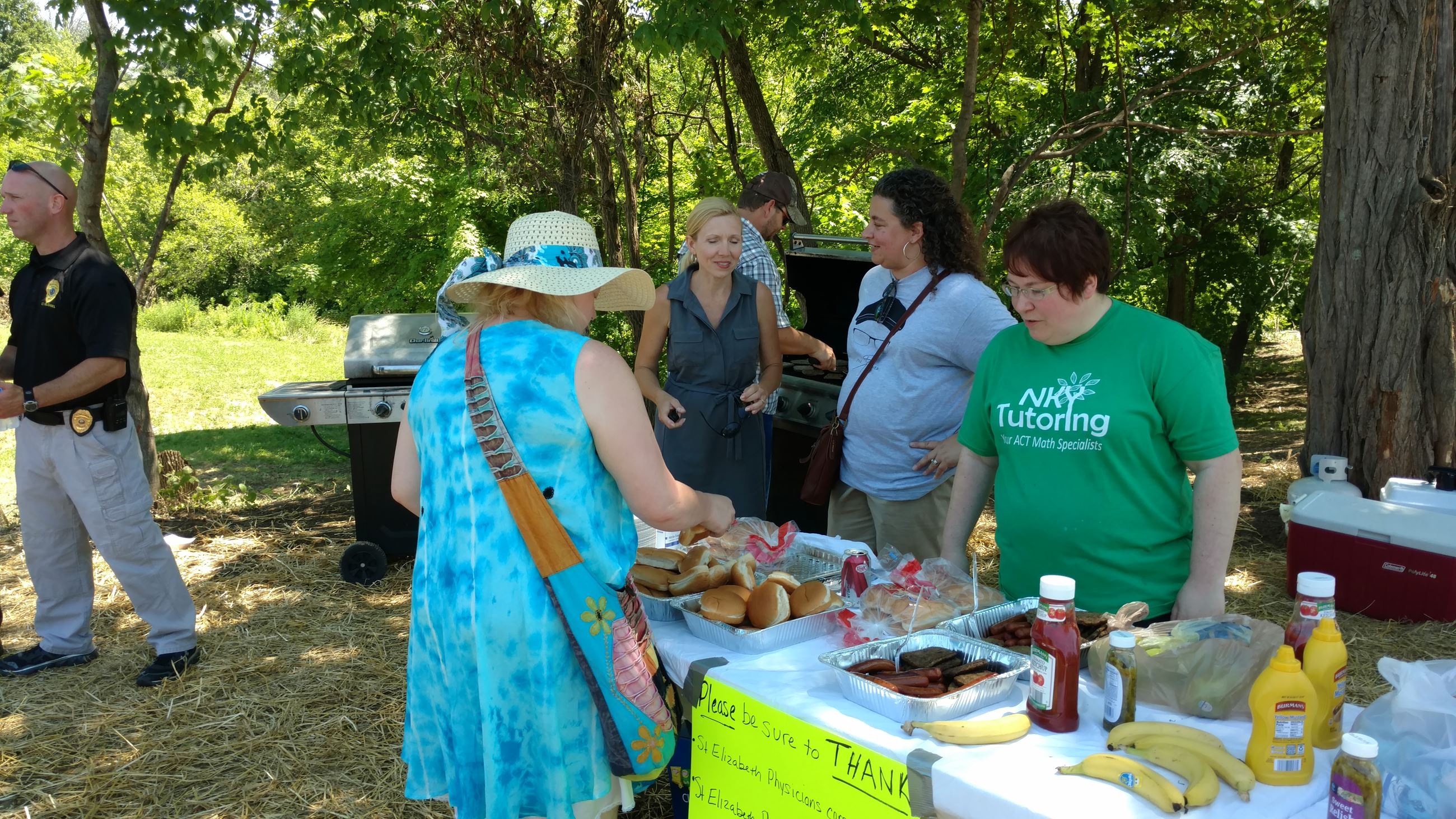 People helping themselves to food and talking at the cookout