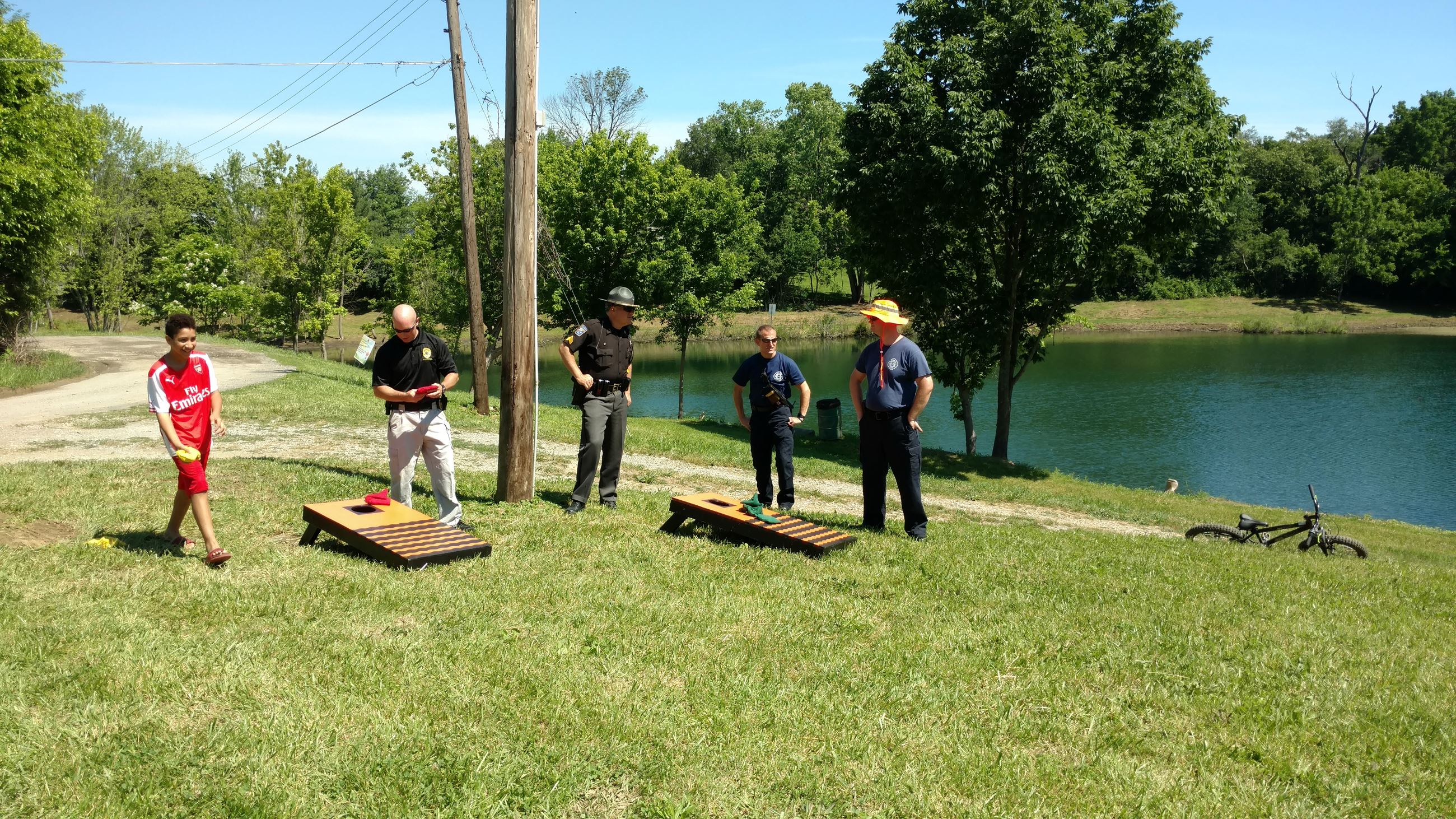 People playing yard games by the lake