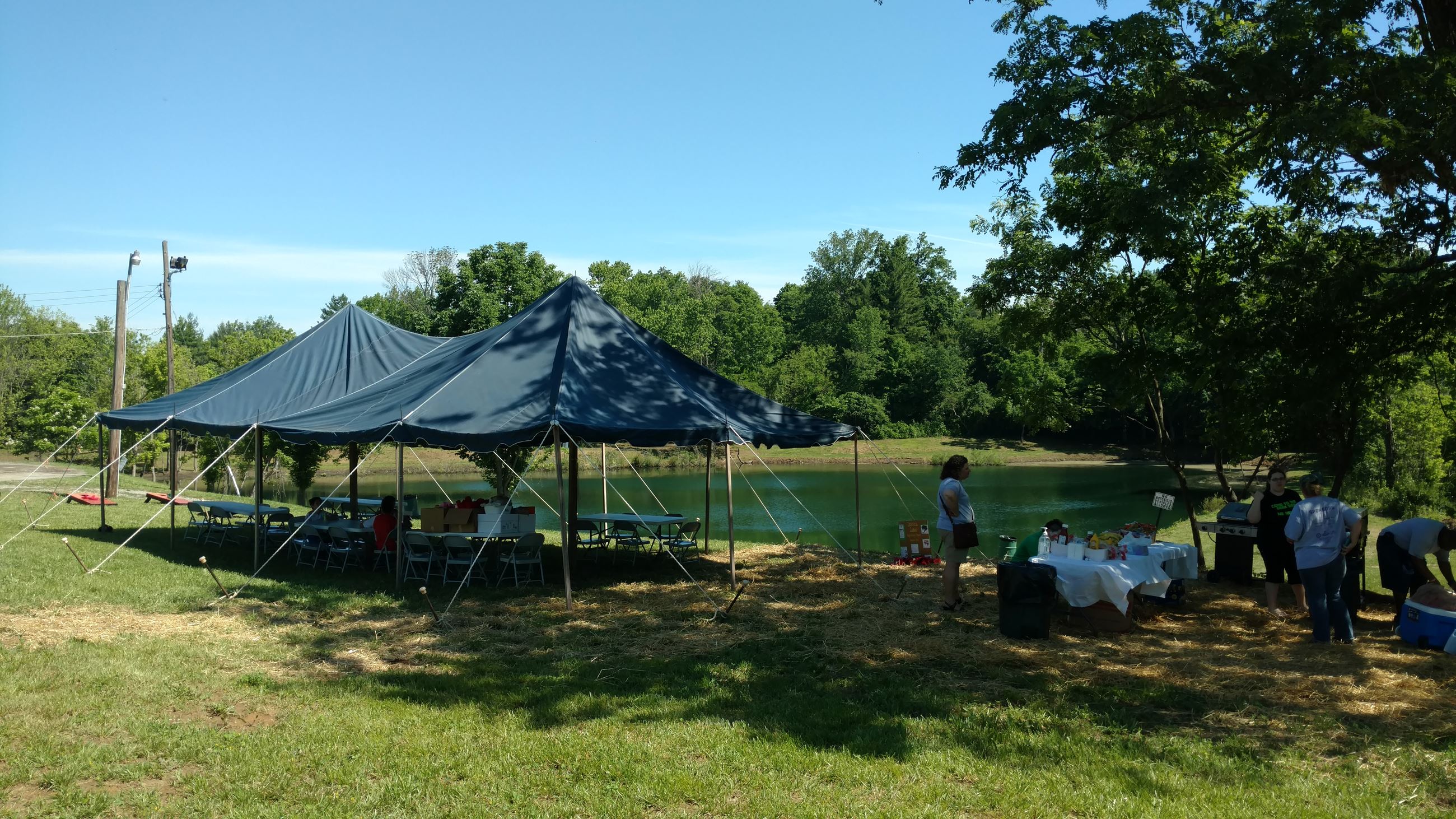 Large tent and table for food set up by the lake