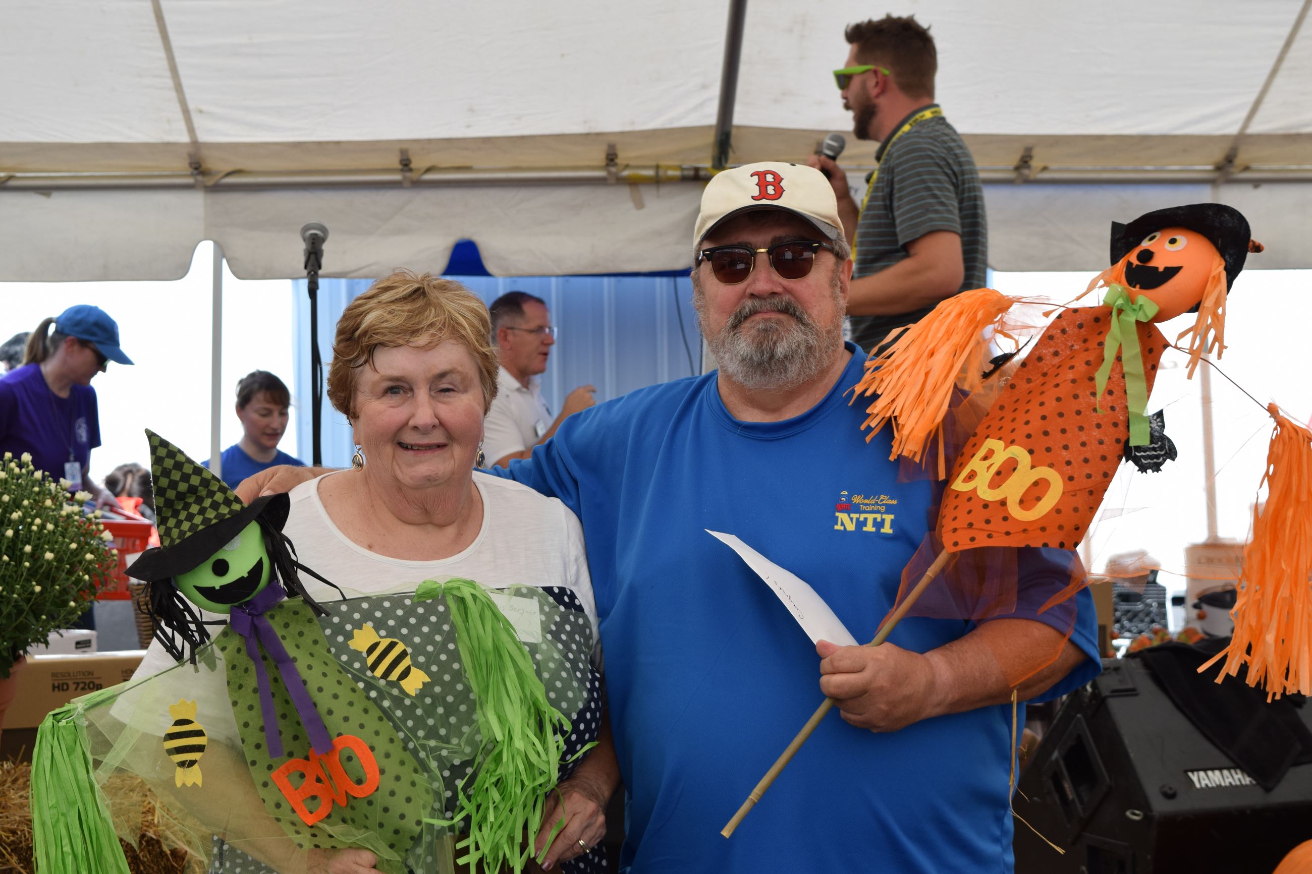 Man and woman holding Halloween decorations