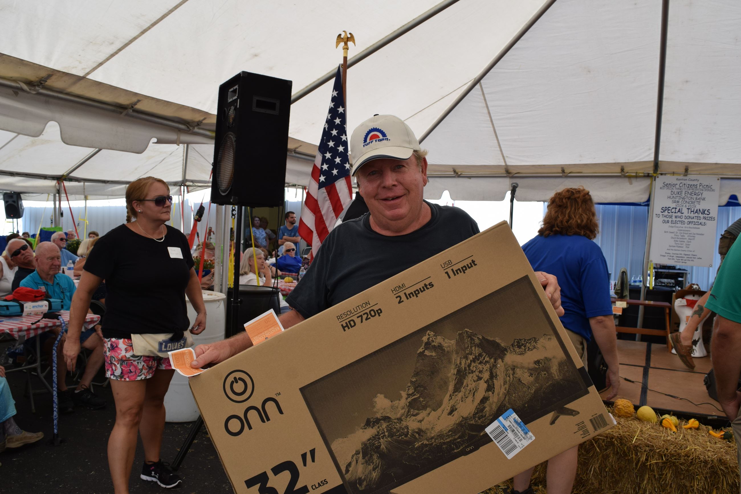 Man holding new television, still in the box