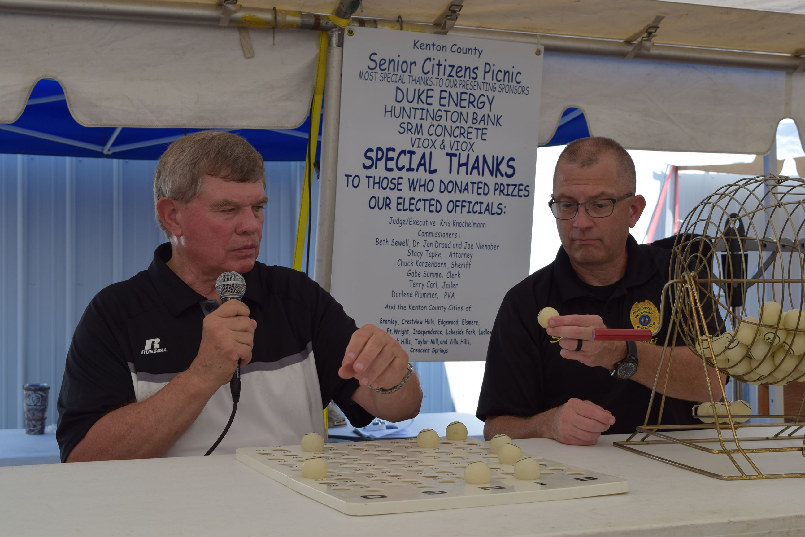 Two men running a Bingo game