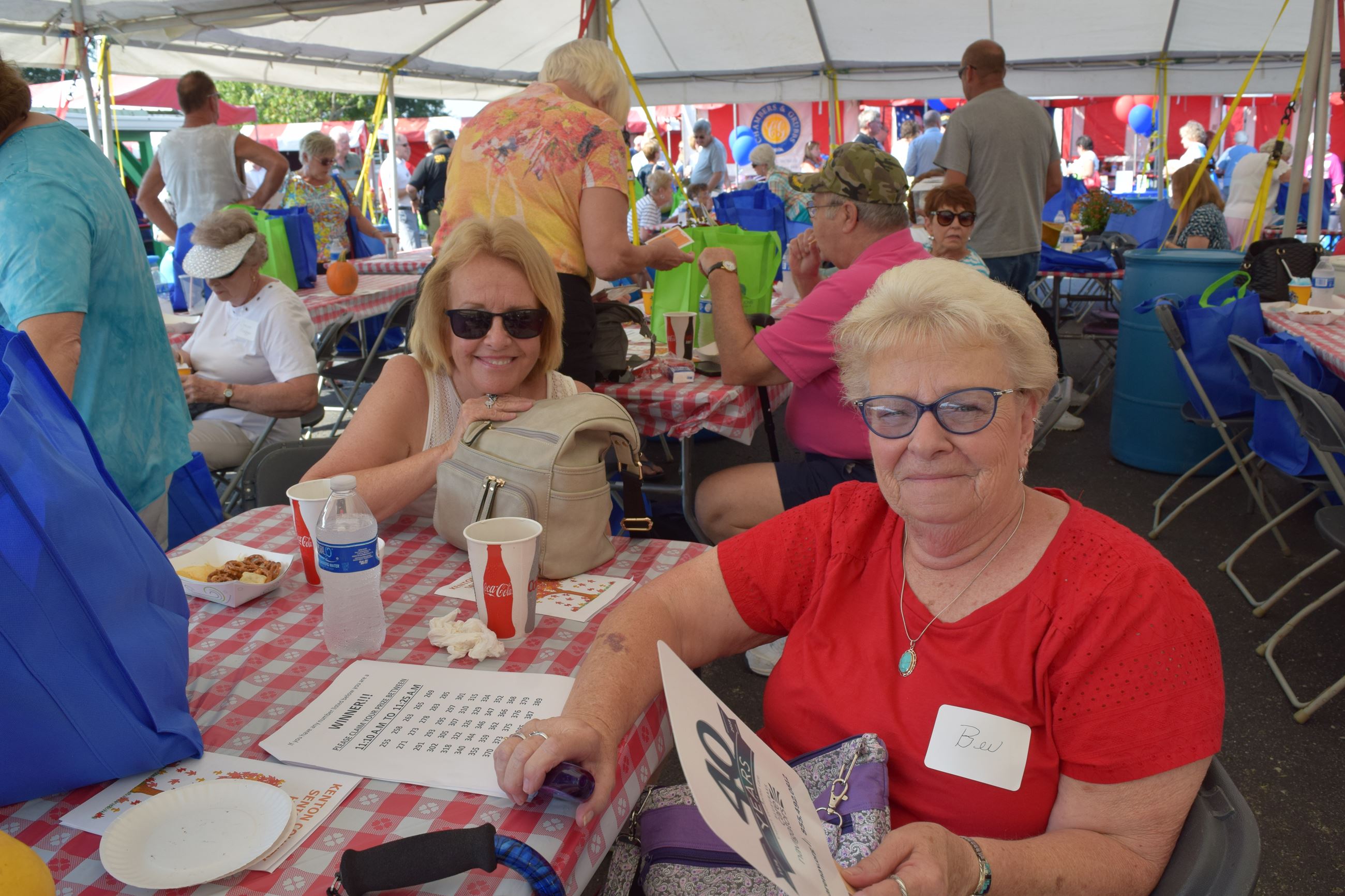 Two women sitting at a table smiling