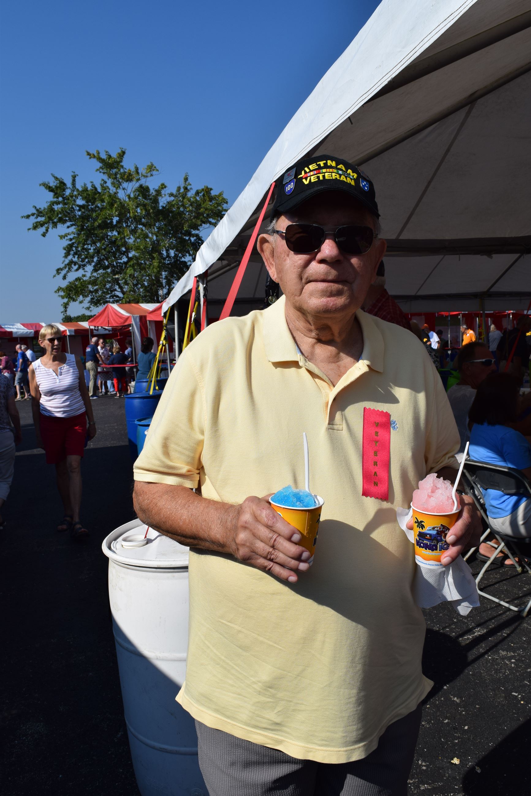 Man holding two snow cones