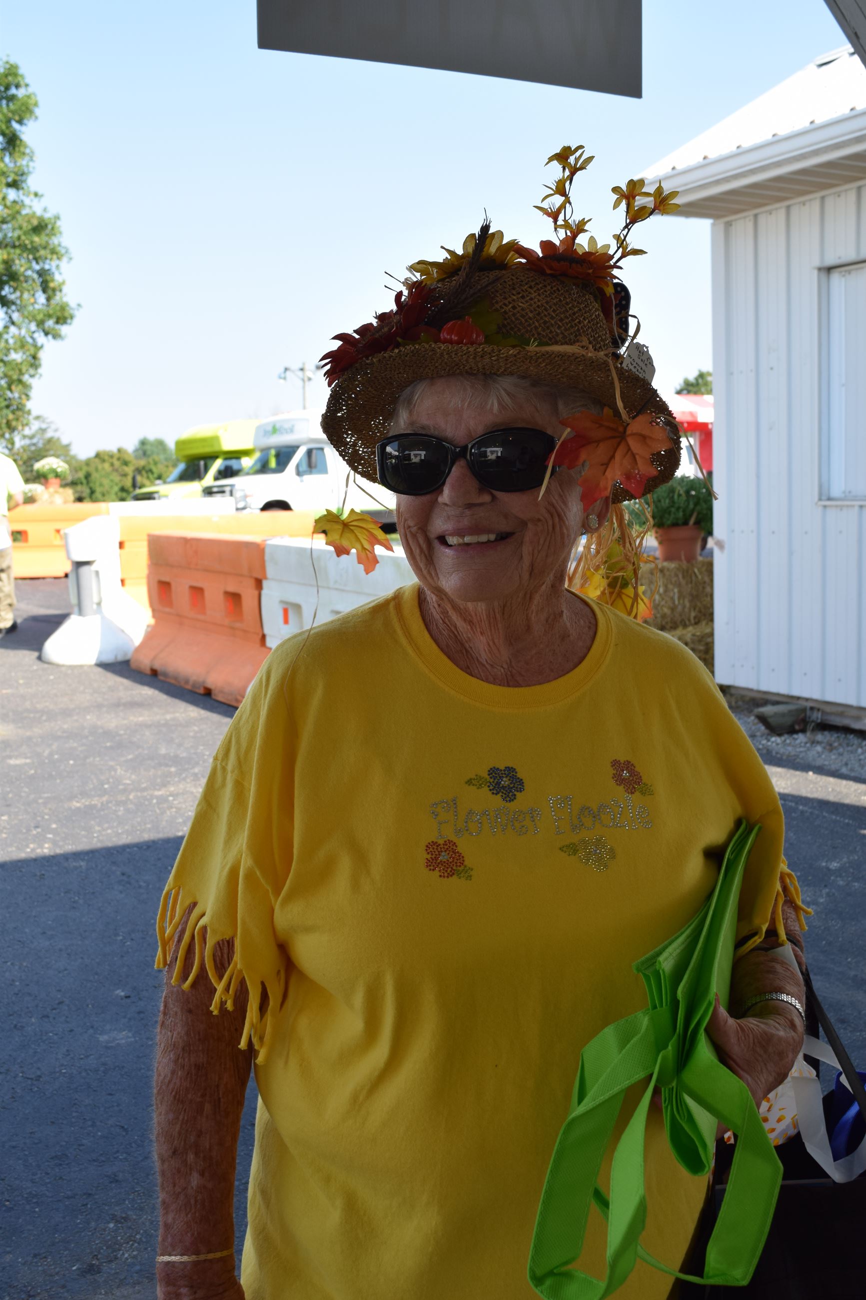 Woman wearing a hat decorated with leaves and flowers