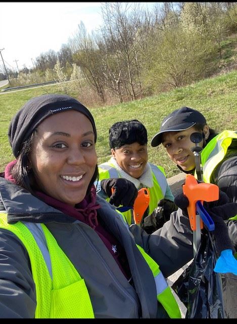 Kentucky Bombers and Covington Athletics members pose for a photo alongside a roadway.